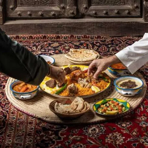 Sharing the meal on the floor majlis